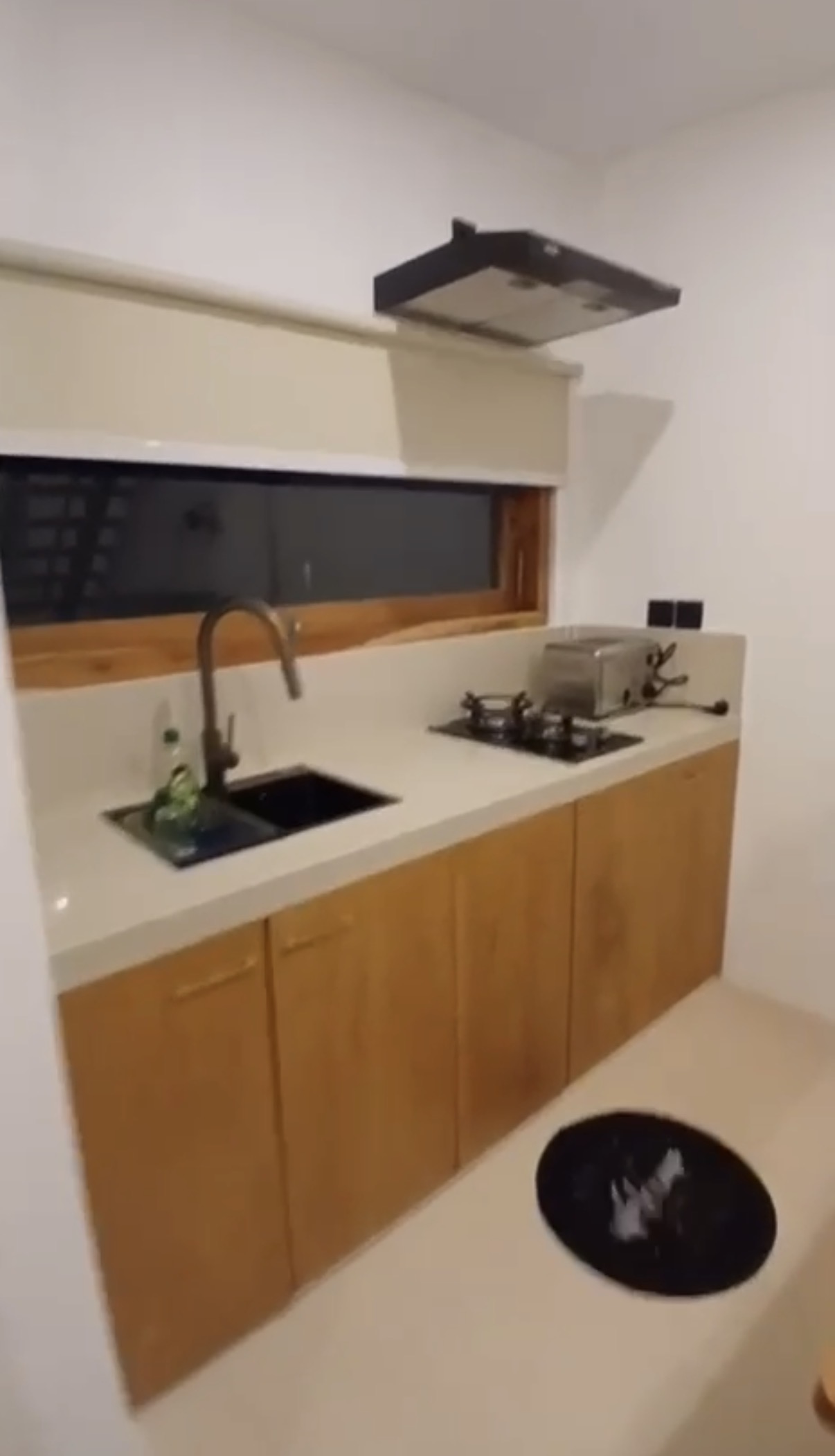 Kitchen with wooden cabinets and gas hob