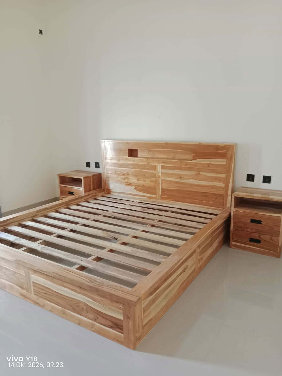 Wooden bed frame and bedside tables in Lombok Stay 11
