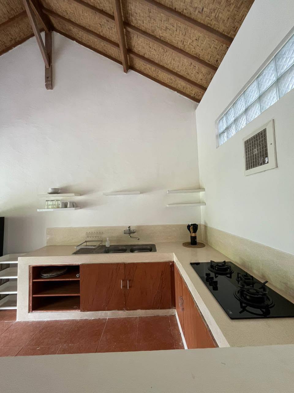 Equipped kitchen with cooking hob and sink