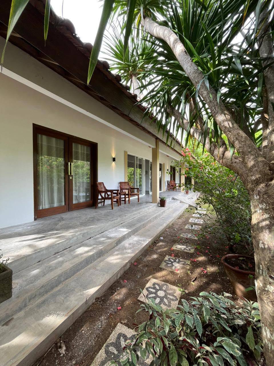 Villa exterior and veranda along landscaped garden