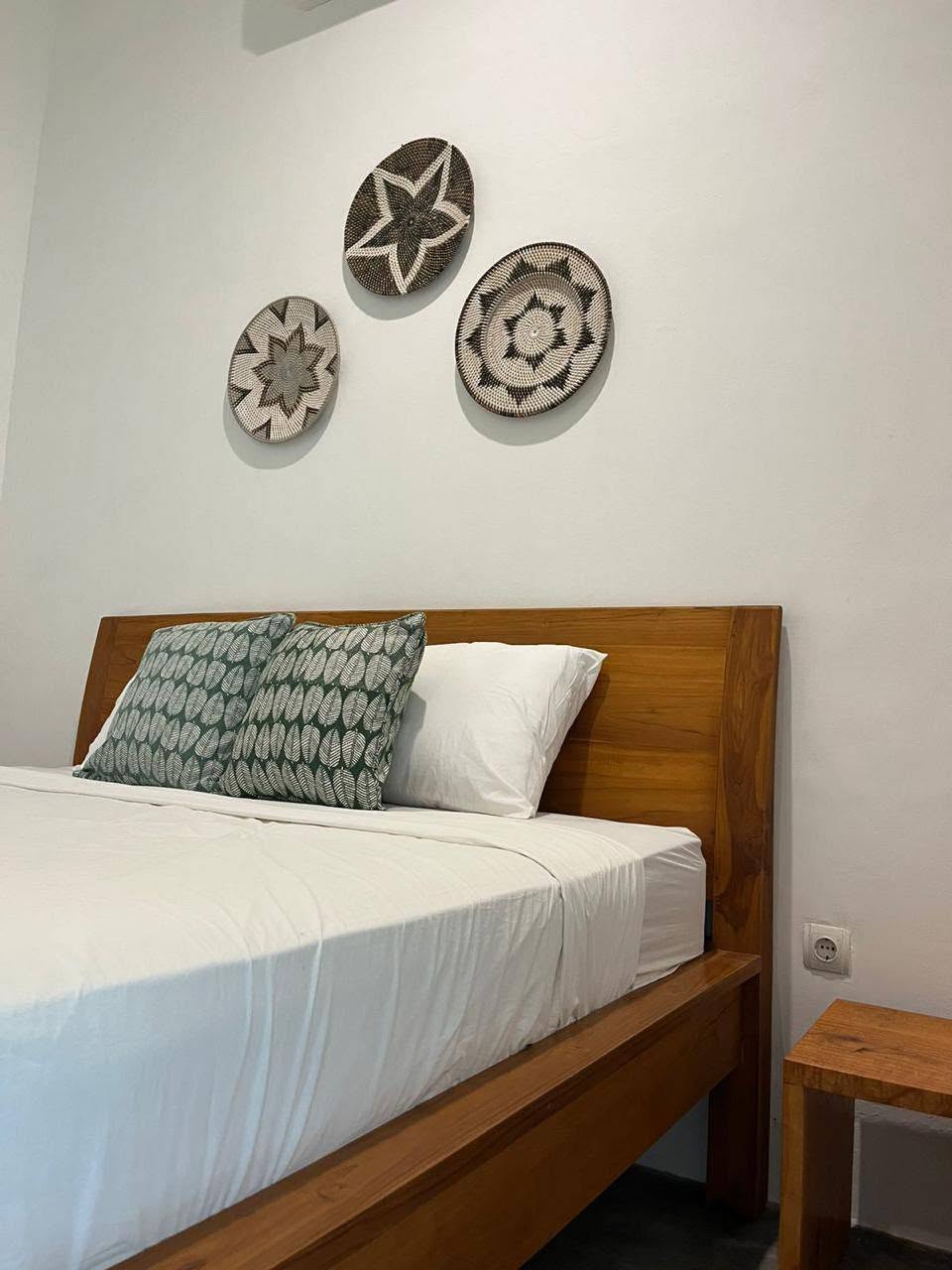 Bedroom with white bed linen and wood furniture