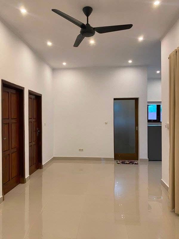 Tiled interior living space in Mengalung two-storey home