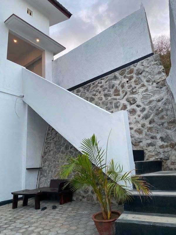 External stairs and stone wall outside the Mengalung family house