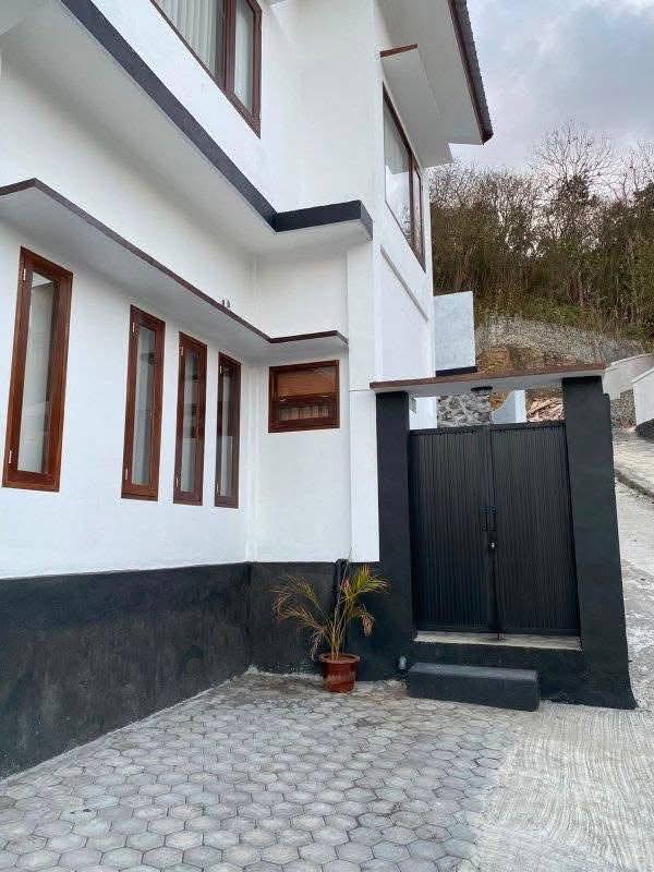 Gated courtyard and side exterior of Mengalung two-storey house