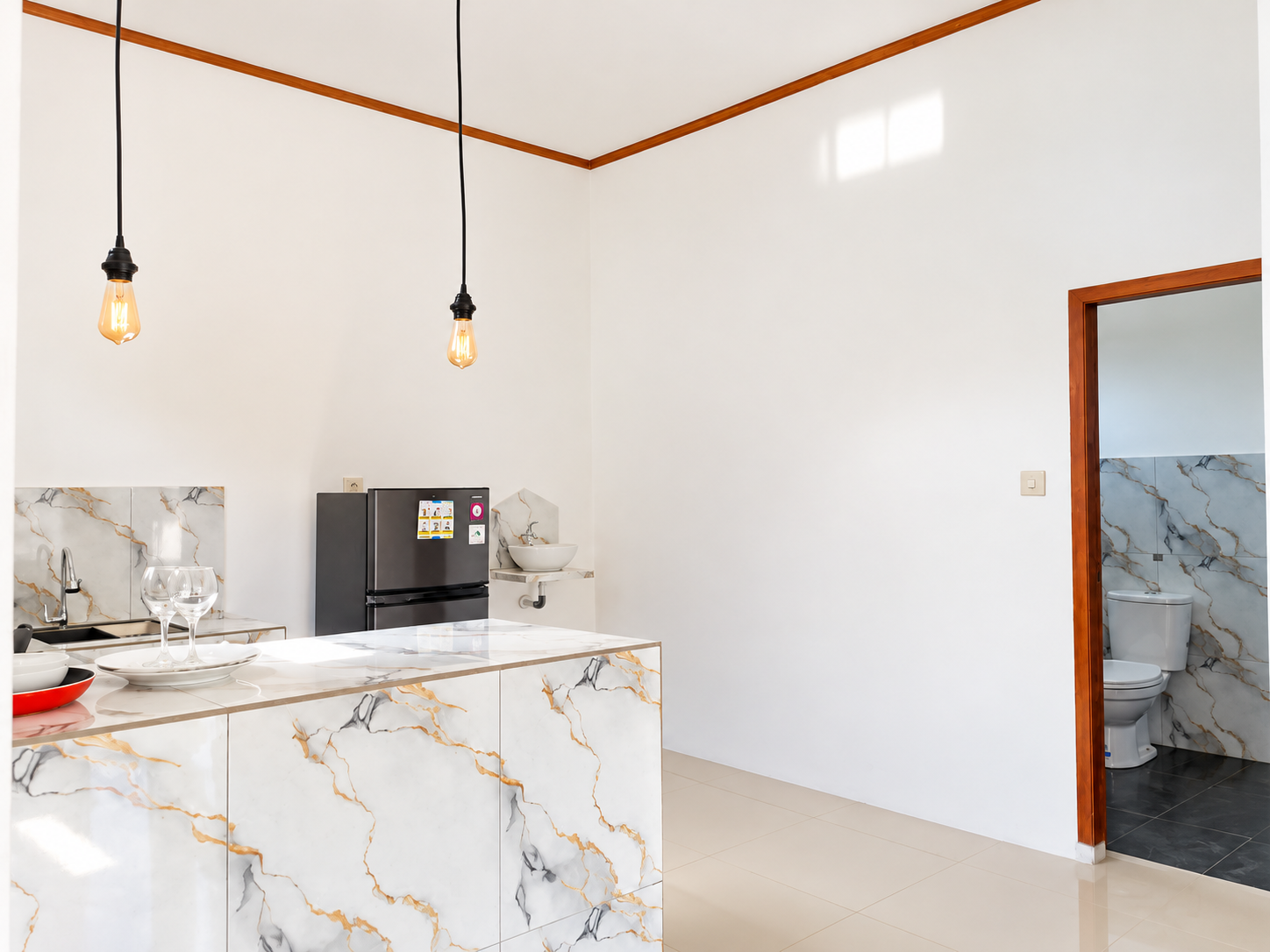 White marble-look kitchen counter, refrigerator and open interior