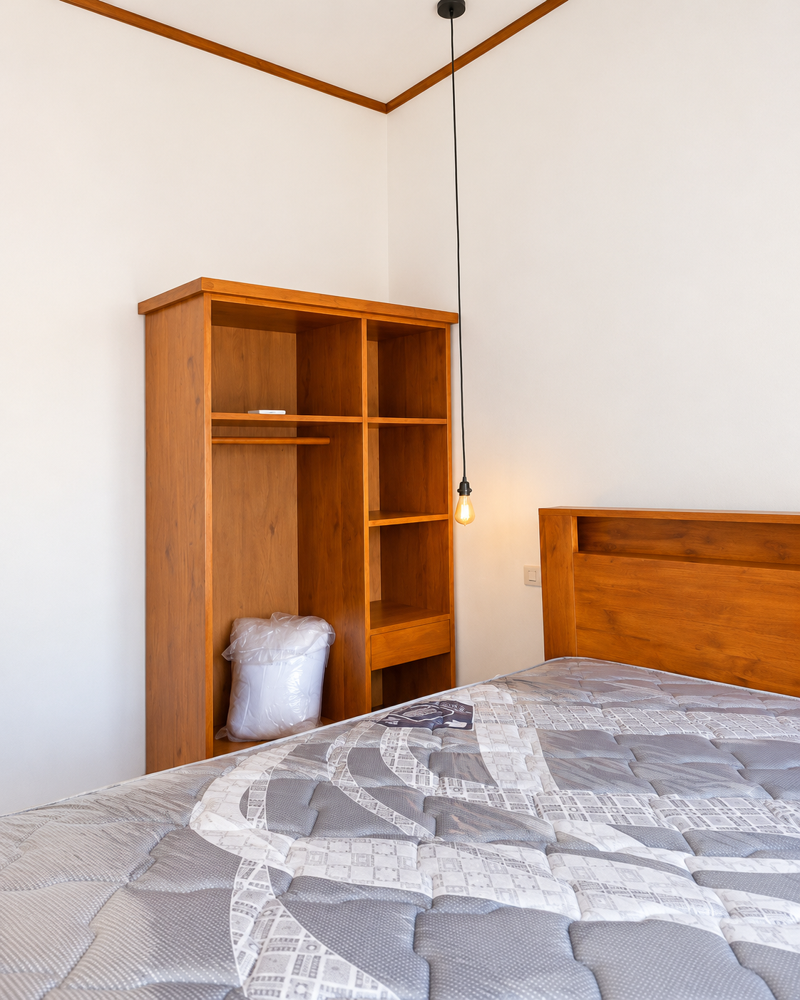 Air-conditioned one-bedroom home with wooden wardrobe and bed