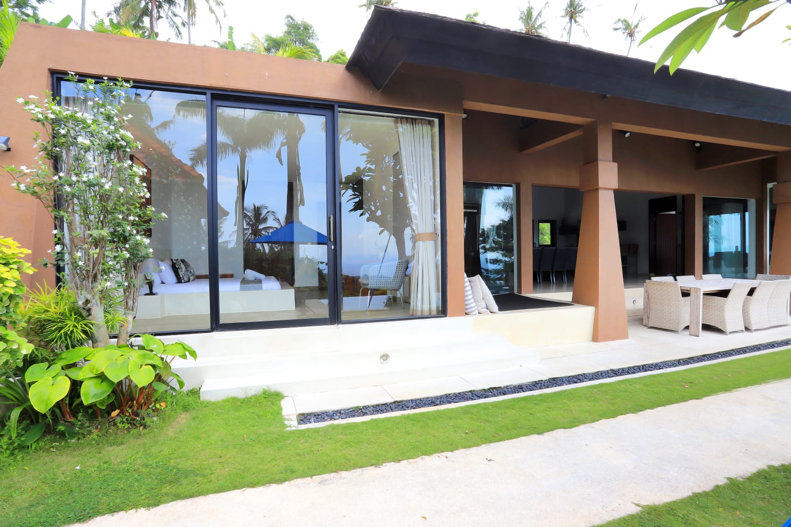 Batulayar Hill villa exterior with wide windows and tropical landscaping