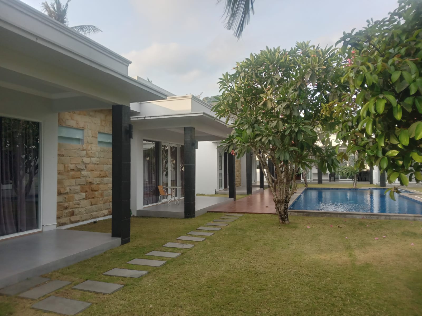 Tropical landscaped garden with paths around the villa and pool