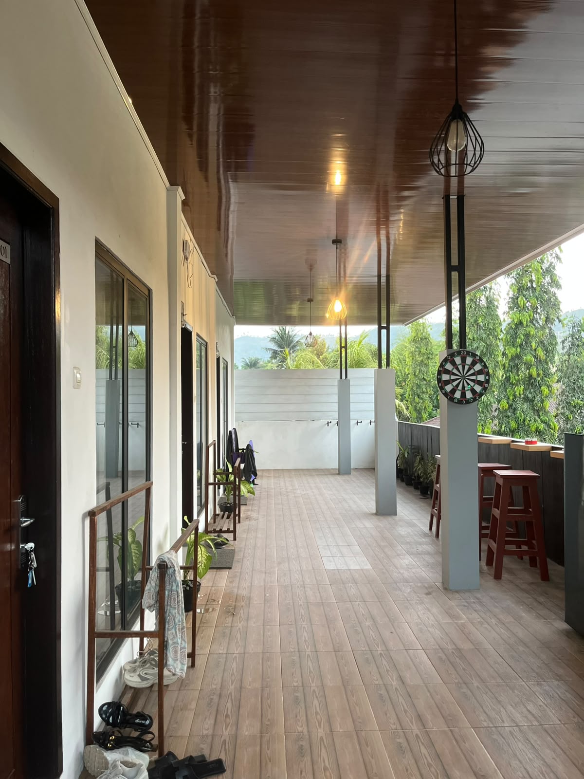 Large covered shared terrace with seating and views at Central Kuta accommodation