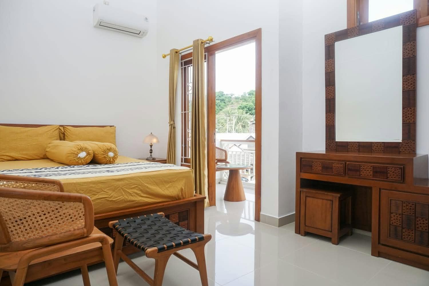 Furnished bedroom with golden bed linen and air conditioning