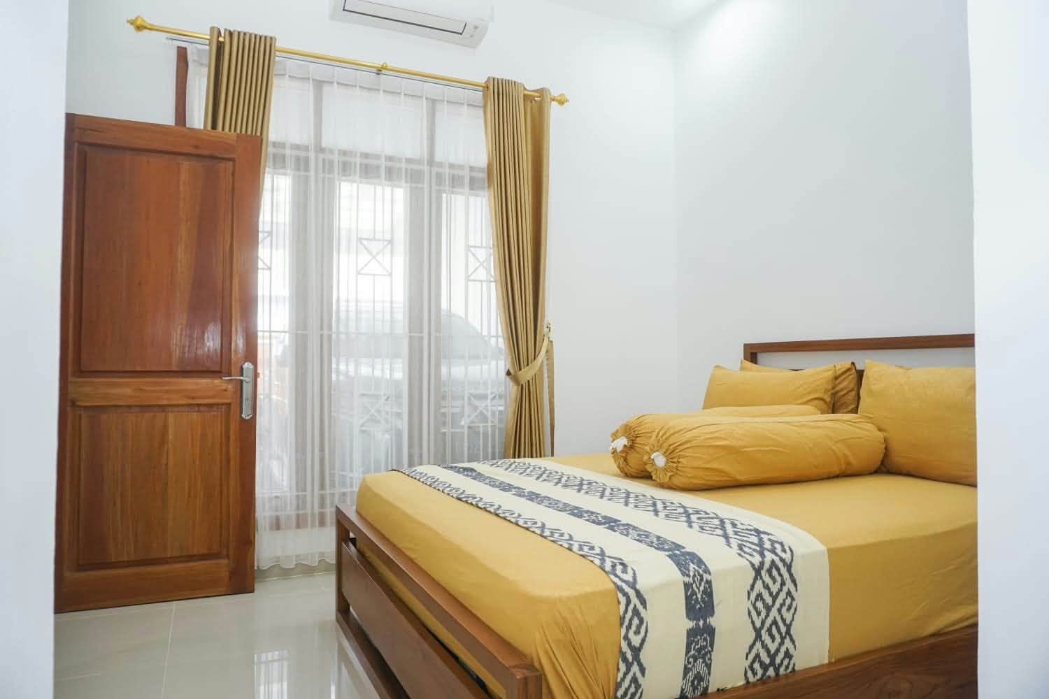 Air-conditioned bedroom with golden bedding