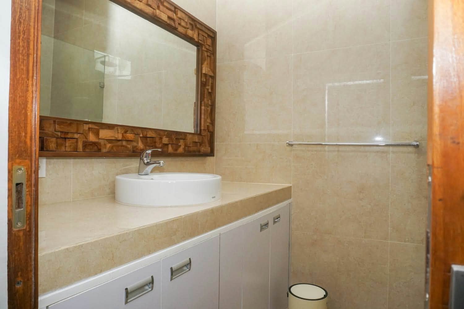 Sink and vanity in tiled bathroom