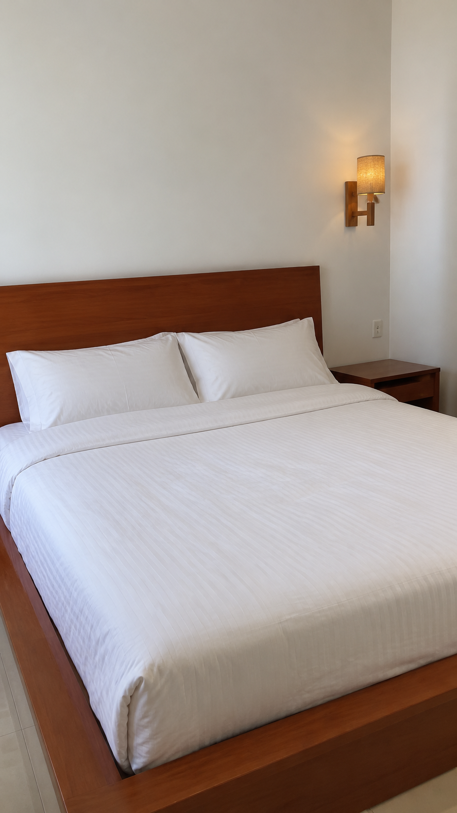 Double bedroom with wooden bed frame and neutral bedding