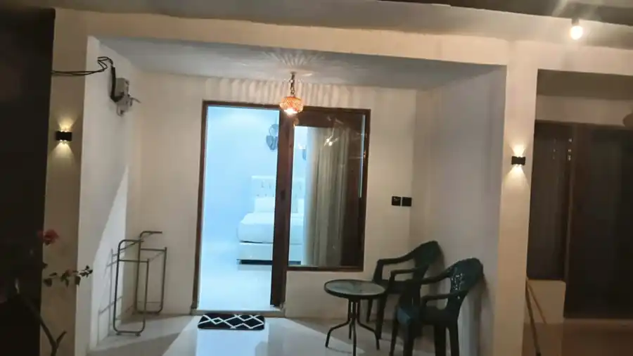 Covered terrace with seating and entrance to the bedroom