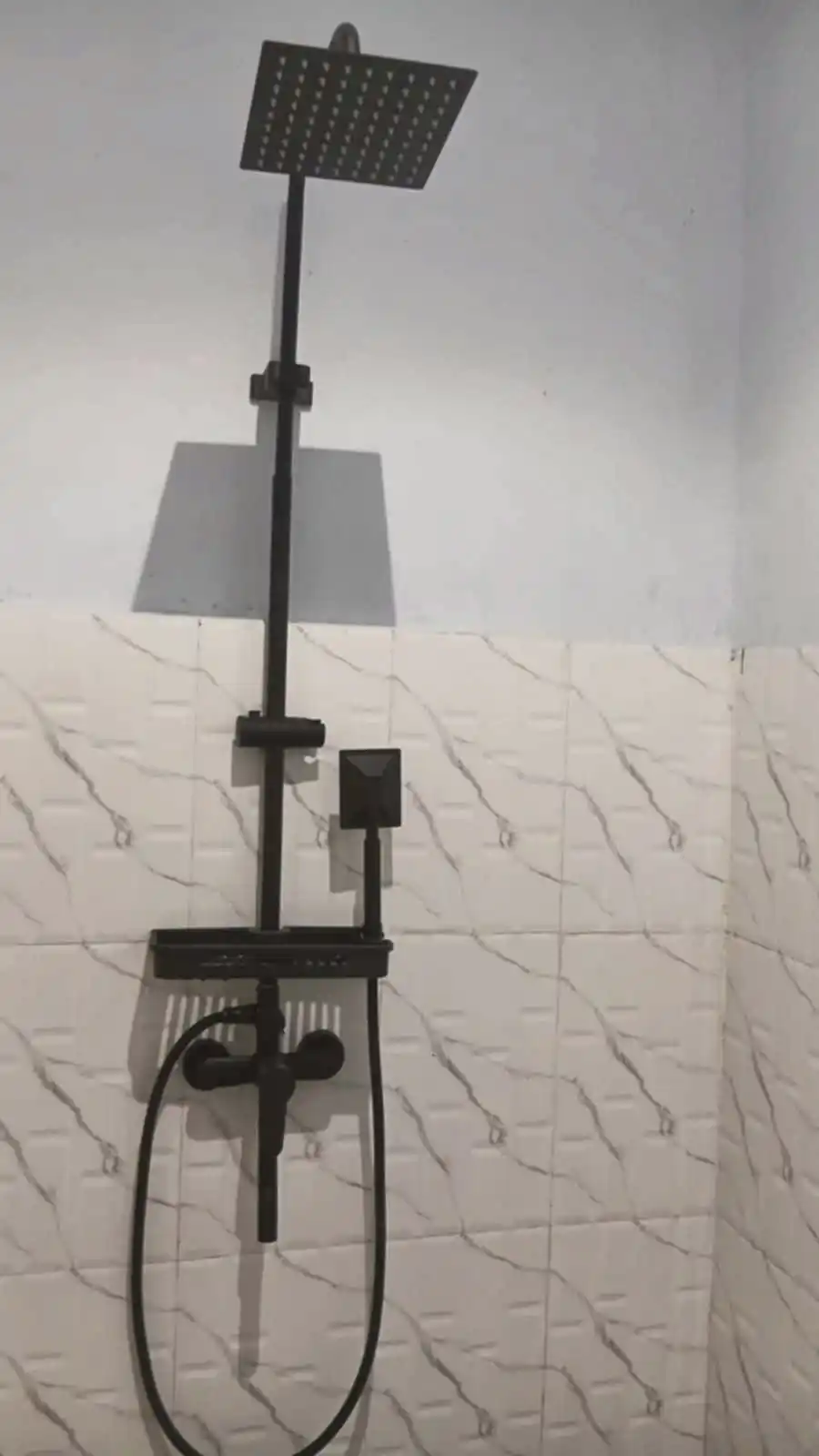 Bathroom with black overhead rainfall shower and handheld shower